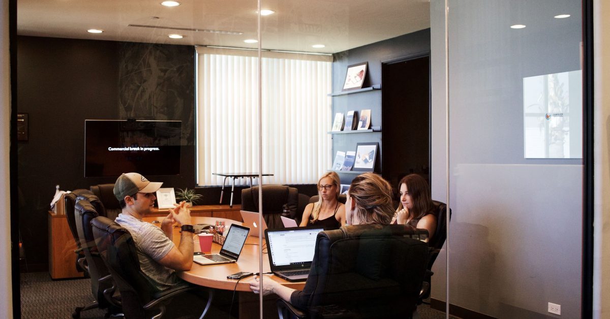 Four People Meeting In A Conference Room