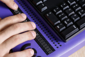 Person using braille keyboard
